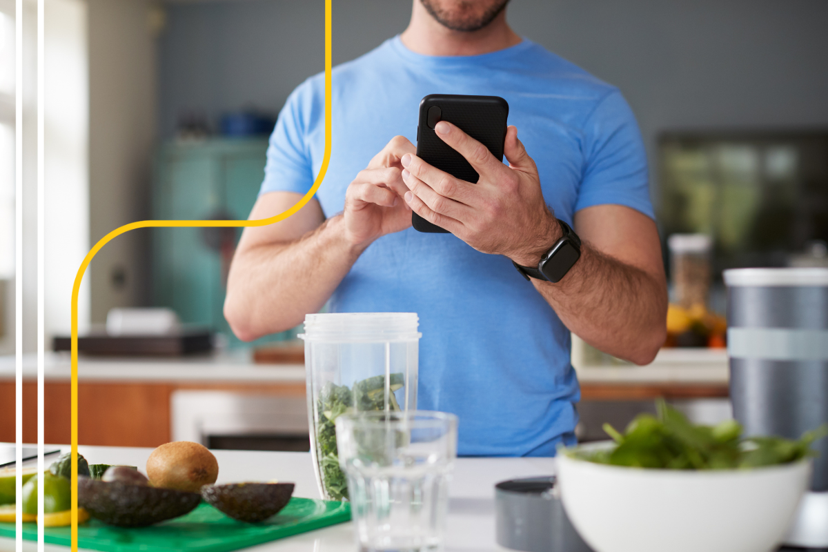 Man checks recipe on phone while making a healthy snack